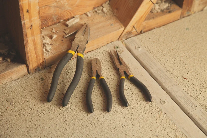 A photo of the 3 Pc Plier Set resting on a workspace floor. 