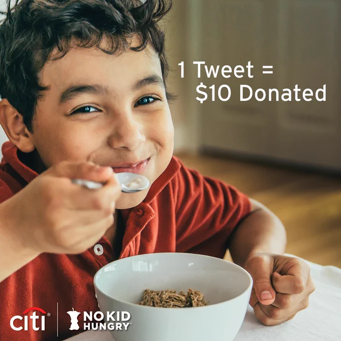Image of a young child smiling while eating cereal. TEXT: 1 Tweet = 100 Meals. Image of child eating bowl of cereal. Citi and No Kid Hungry logo lock up.”

