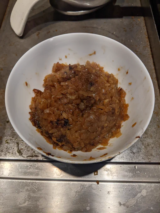 Caramelized onions in a white bowl.
