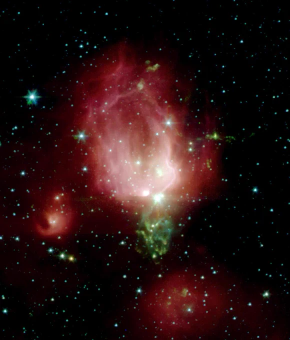 These bright young stars are found in a rosebud-shaped (and rose-colored) nebulosity known as NGC 7129. The star cluster and its associated nebula are located at a distance of 3300 light-years in the constellation Cepheus. They appear in the tapered shape of a rosebud with bright white and pale pinks at the base giving way to deeper rose on the tip and edges. Away from the main nebula and its young cluster are two smaller nebulae, to the left and bottom of the central "rosebud," each containing a stellar nursery with only a few young stars. Credit: NASA/JPL/Caltech/Harvard-Smithsonian CfA