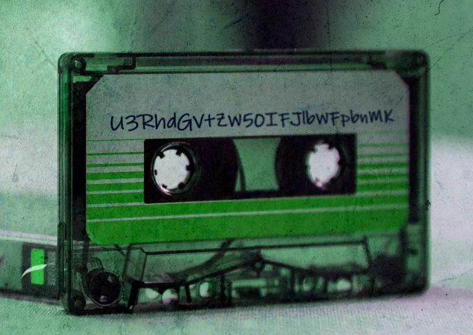 A green-coloured cassette tape. Written on the cassette tape U3RhdGVtZW50IFJlbWFpbnMK .