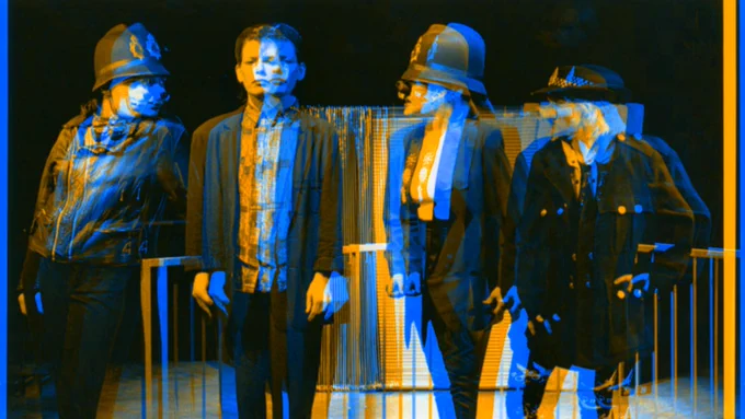 a black and white photo from our archive of women on stage dressed as police wearing pig noses. There is a glitchy blue and orange effect on the image.