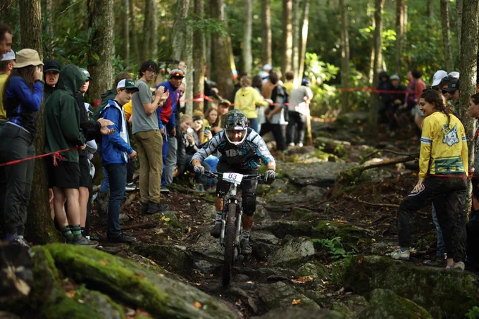 Ricky wincing while still riding down big rocks