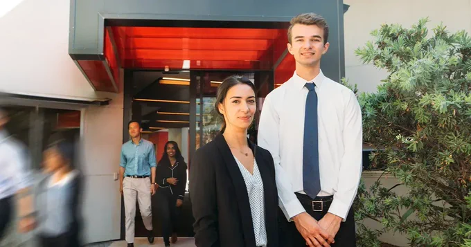 Photo of two people in business attire