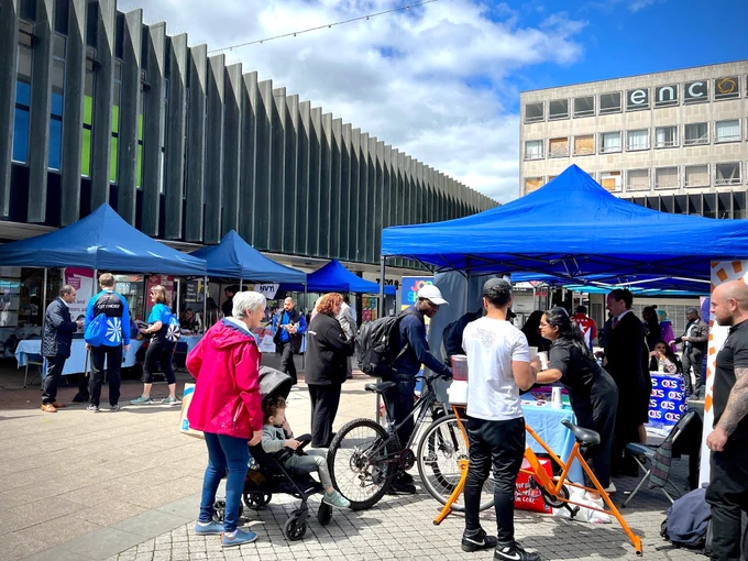People visiting different information stalls at a previous jobs event in the Bull Yard