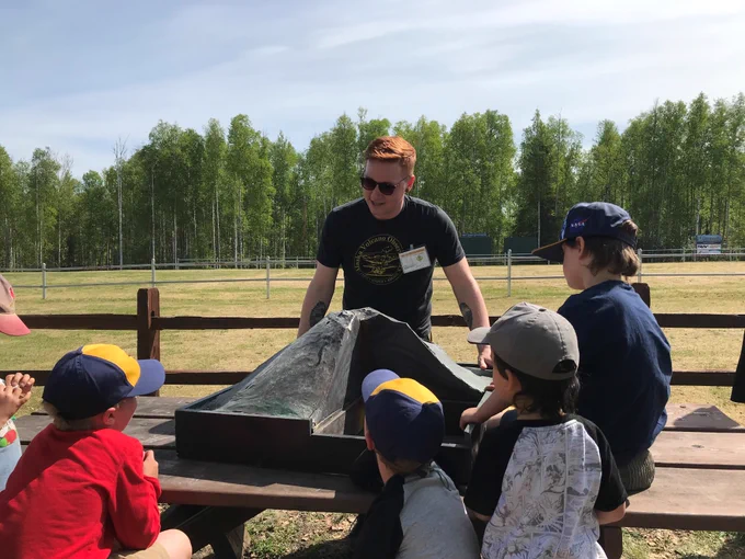 AVO Scientist talking volcanoes on a sunny day with cub scouts