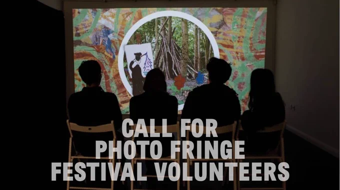photo of 4 people sat watching a screening of new artwork by artist Anne-Marie Atkinson