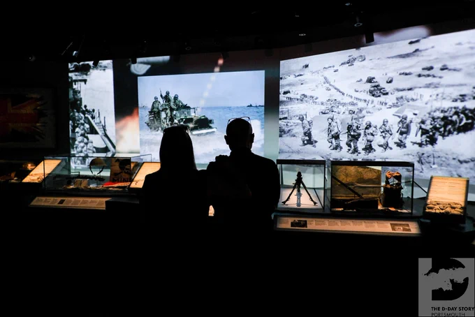 Photo showing silhouette of two people looking at The D-Day Story galleries.
