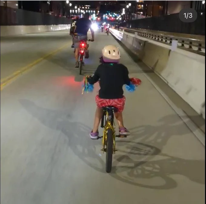 Family riding bikes down the 14th street viaduct from Union City into Hoboken