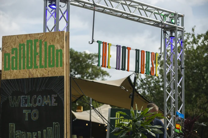 'The Hot House' signage at Dandelion Festival Inverness, each letter is a unique colour with a mix of greens, purples, oranges and yellows 