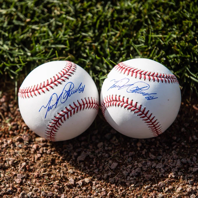 Miguel Cabrera authenticated autographed baseballs with signature in blue ink displayed on grass and warning track of Comerica Park