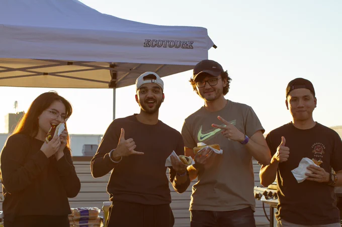 A quartet of students pose with their all-beef hot dogs.