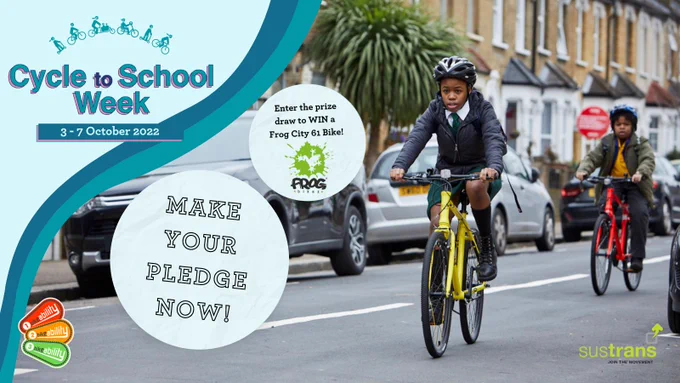Image includes 2 school children riding their boke as part of Cycle to School Week. 