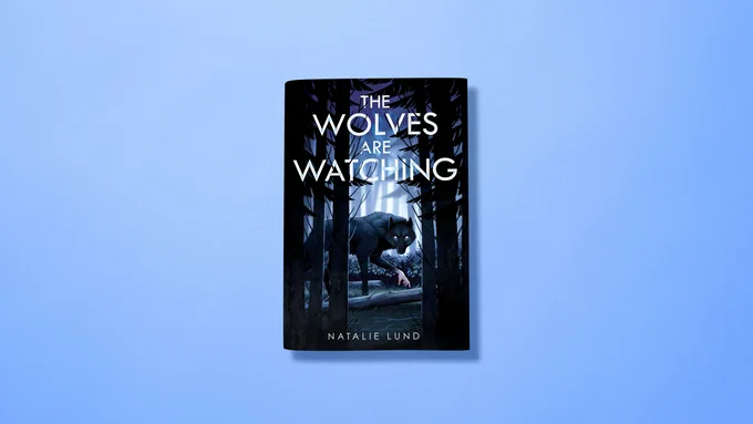 A flatlay photo of the book The Wolves are Watching by Natalie Lund