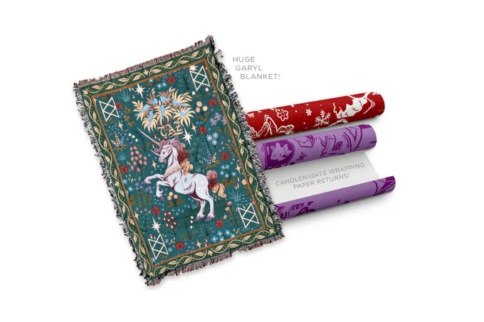 The October McElroy merch items. On the left is a teal and green tapestry blanket with Garyl in the center of it. He’s rearing back on his hind legs and has a flowing mane and tail. There are flowers around him. Above him is a tree with blue birds. There is a B.o.B. rune in each corner. To the right is two rolls of wrapping paper: one a red MBMBaM roll and the other a purple TAZ roll.