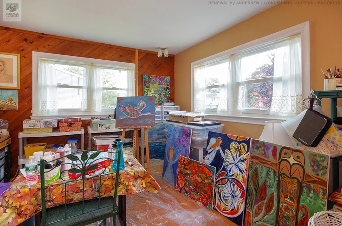 Bright and fun artist's studio with new white double hung windows we installed. This lovely space with wood accent wall and creative atmosphere looks great with these new white replacement windows we installed. Get started replacing your windows with Renewal by Andersen of Long Island, serving Suffolk, Nassau, Queens and Brooklyn.