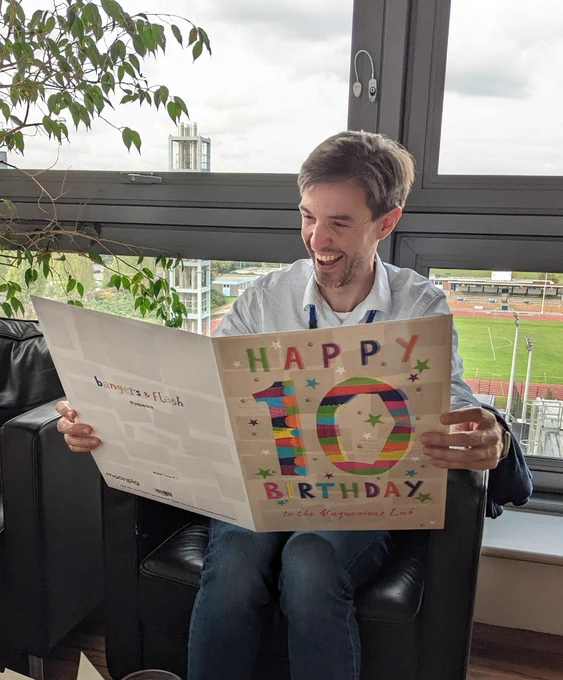 Juanma smiling with a giant tenth birthday card