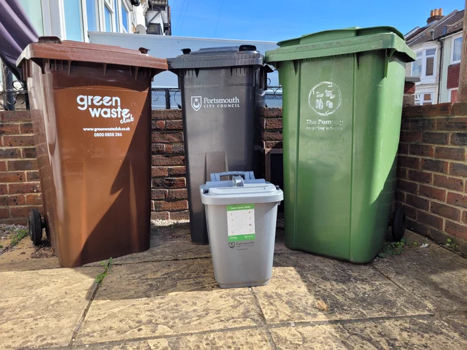 Portsmouth city council waste recycling bins, in the forecourt of a house.