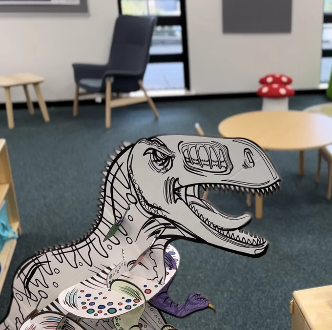 A large cardboard T-Rex ready to be coloured in