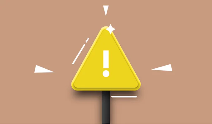 Yellow road sign with a white exclamation mark.