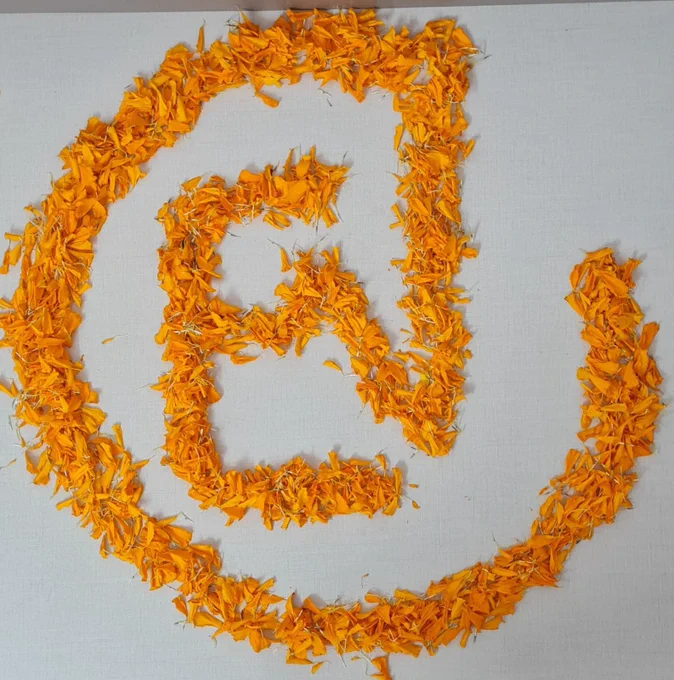 Engenext logo created with merigold flower petals.