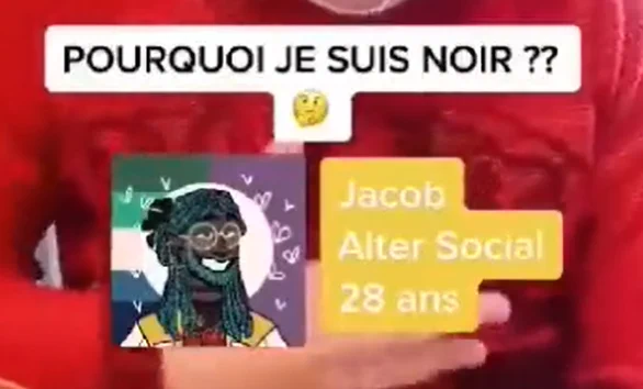 Screen anonymisé d'un blanc venant d'une vidéo.
Le sous-titre dit : "Pourquoi je suis noir 🤔 ??"
Avatar d'une personne Noire darkskin avec des dreadlocks colorés. Ce serait son Alter Social, appelé Jacob, 28 ans.