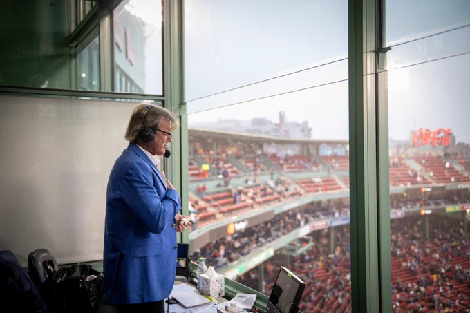 Dennis Eckersley puts his hand over his heart as a tribute video airs on the Fenway Park video board celebrating his 50 years in Major League Baseball. 