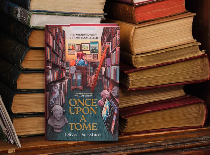 A copy of Once Upon A Tome: Misadventures of a Rare Bookseller, against a backdrop of rare books we shoved in a cupboard once and forgot about. 