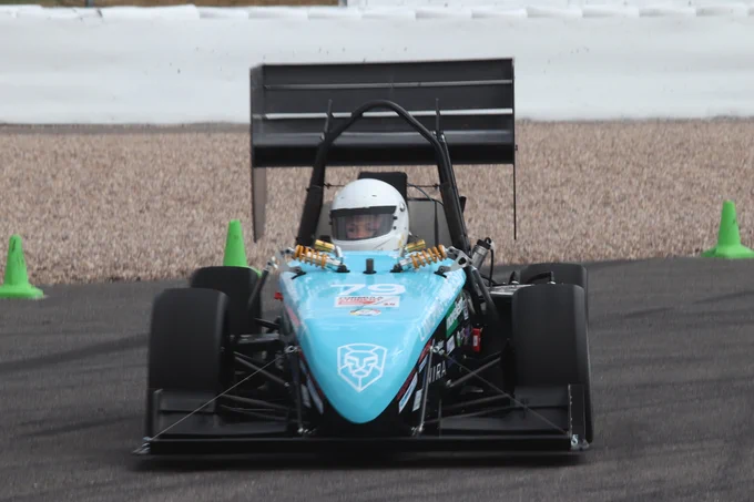 University of Linkoping's blue and black car prepares to take a corner on the sunny Sprint Course during Formula Student 2018 on Copse Corner at Silverstone.
