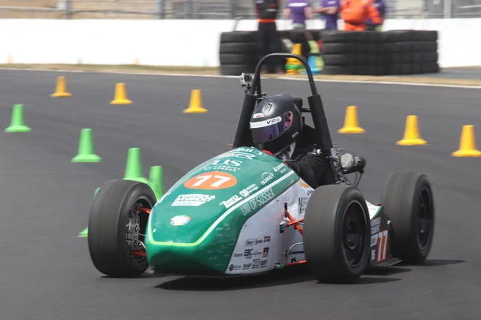 University of Surrey's green and white car runs straight section of the sunny Sprint Course during Formula Student 2018 on Copse Corner at Silverstone.