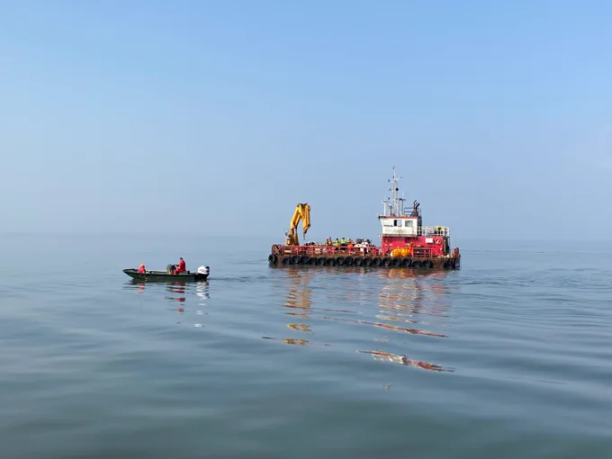 Two workboats in open, calm water