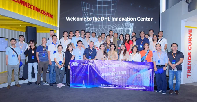 Group photo in front of a DHL Asia Pacific Innovation Center sign