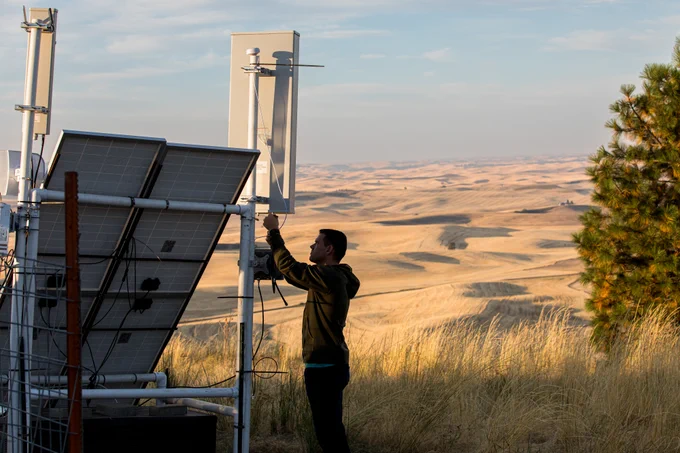 Person touching equipment in a rural setting