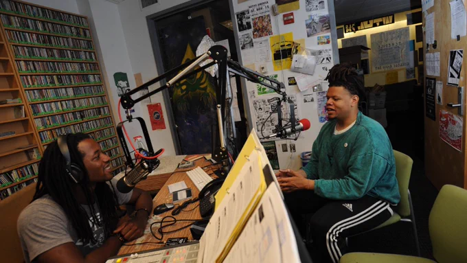 Two WTUL volunteers chat on air in the WTUL studio.