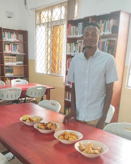 Hatua Library Fellow and a table with snacks