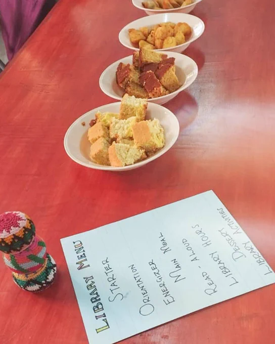 A library program with the day's Read Aloud program on top of a table and snacks 