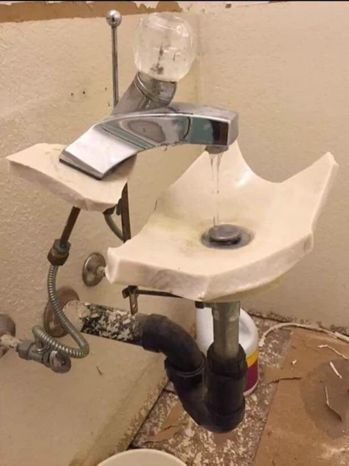 Broken sink, with all parts functional, bowl is broken, the tap's casing is gone, you can see all the pipes, but still works.