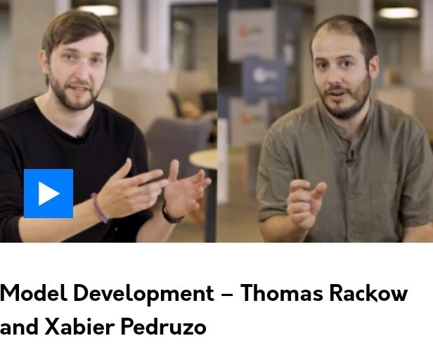 Two scientists from ECMWF, the European Centre for Medium-Range Weather Forecasts, are explaining how the IFS weather forecasting model is further developed. The two are gesturing with their hands, in order to make the difficult topic easier to grasp.