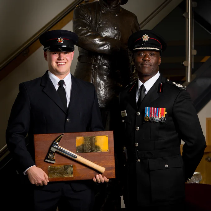 Trainee Firefighter Matthew Taylor pictured being awarded the Silver Axe Award, with Deputy Chief Fire Officer Wayne Brown