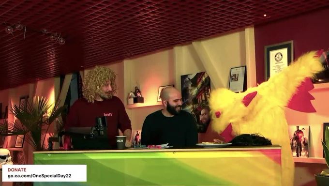 Tom, Feras looking at Max in a chicken costume dabbing