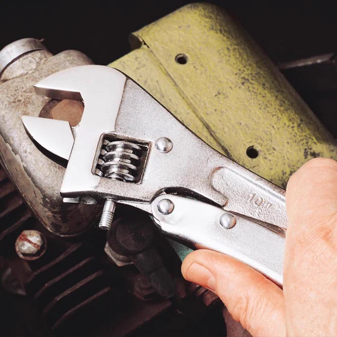 An image of the movable jaw on the 10 in MaxGrip Locking Adjustable Wrench tightly gripping a fastener. 