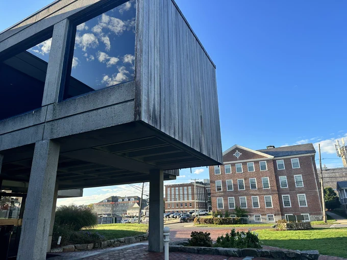 View of Swope Hall at MBL Science. The clouds are reflected in the window.