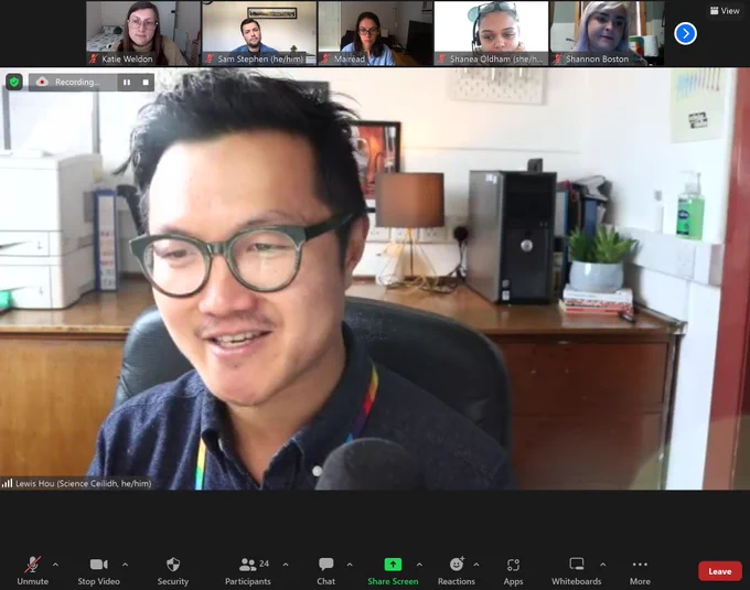 Screenshot of a zoom call with speaker in full screen 5 other attendees shown along the top