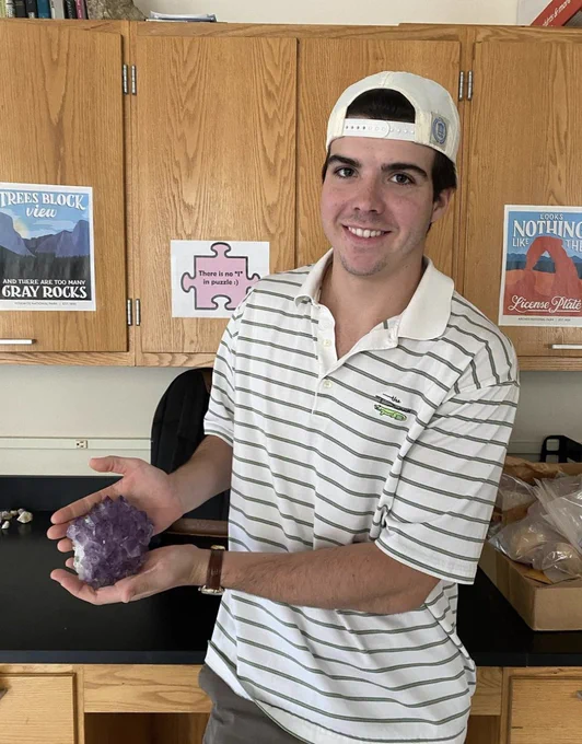 One of our alumni, Nelson Daniel, won the amethyst cluster. Pictured is his son Spencer receiving the prize for his dad.