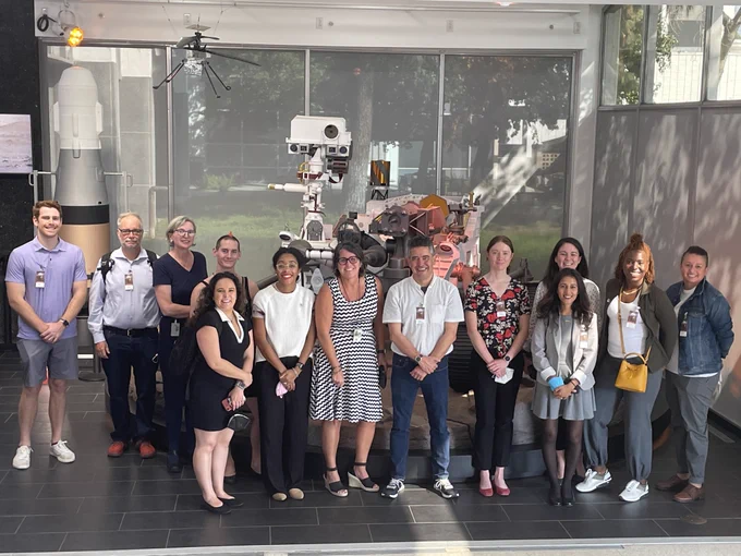 TOPS team members and panelists posing for a photo with another Mars Rover at JPL.