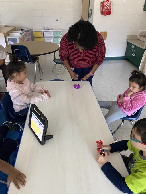 Mrs. Scarboro and a student make sure coding mouse doesn’t fall