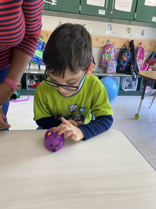 Student coding a purple mouse