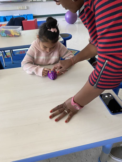 Student coding a purple mouse