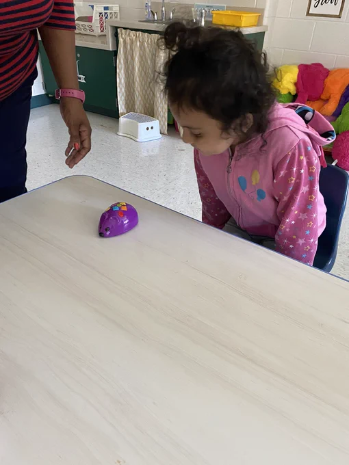 Student coding a purple mouse