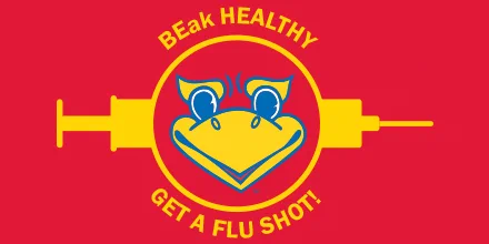 Illustration of a large needle with the Jayhawk beak graphic in the center. Text reads ”BEak HEALTHY, GET A FLU SHOT!”